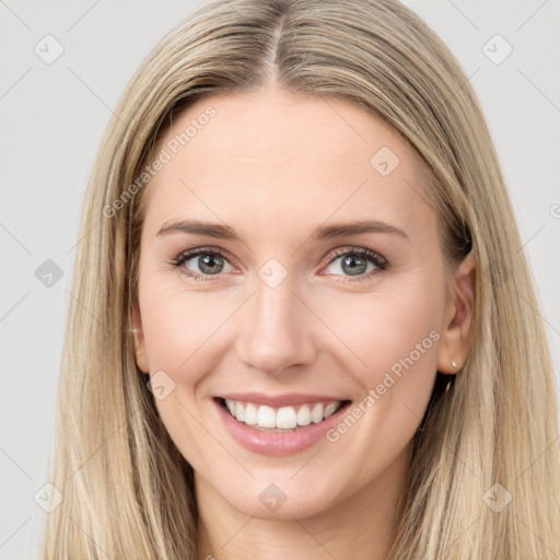 Joyful white young-adult female with long  brown hair and blue eyes