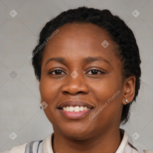 Joyful black young-adult female with short  black hair and brown eyes