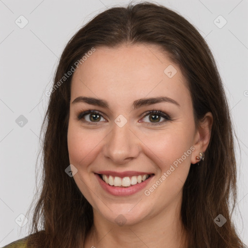 Joyful white young-adult female with long  brown hair and brown eyes