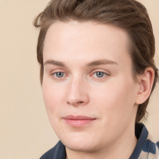 Joyful white young-adult male with medium  brown hair and grey eyes