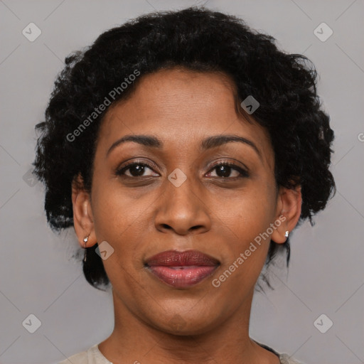 Joyful black adult female with short  brown hair and brown eyes