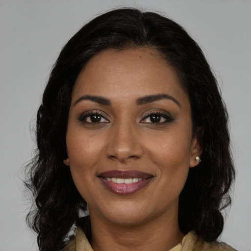 Joyful black young-adult female with medium  brown hair and brown eyes