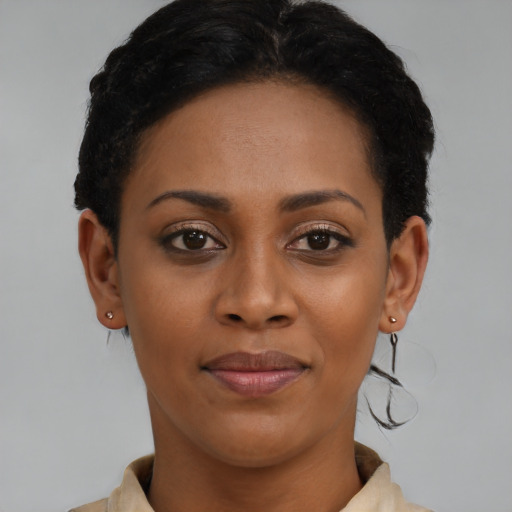 Joyful black young-adult female with short  brown hair and brown eyes