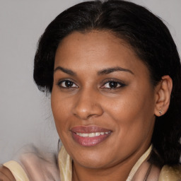 Joyful black adult female with medium  brown hair and brown eyes