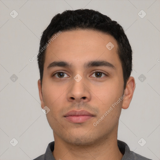 Neutral latino young-adult male with short  black hair and brown eyes