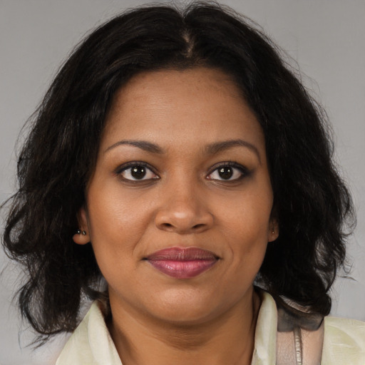 Joyful black young-adult female with medium  brown hair and brown eyes