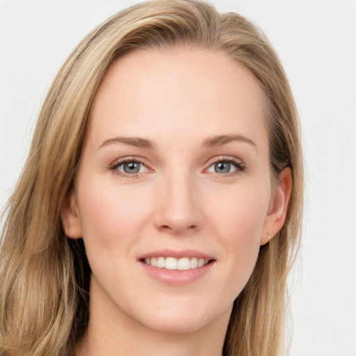 Joyful white young-adult female with long  brown hair and blue eyes