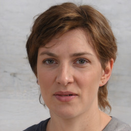 Joyful white adult female with medium  brown hair and grey eyes