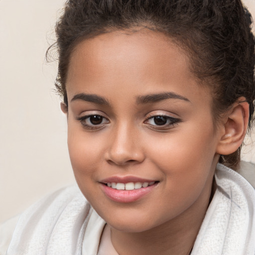 Joyful white child female with short  brown hair and brown eyes