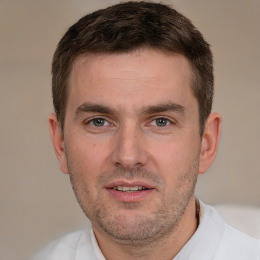 Joyful white adult male with short  brown hair and brown eyes