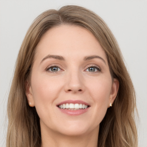 Joyful white young-adult female with long  brown hair and grey eyes