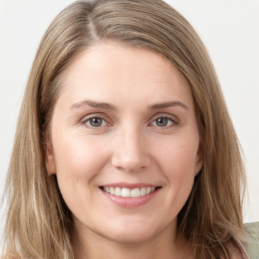 Joyful white young-adult female with long  brown hair and grey eyes