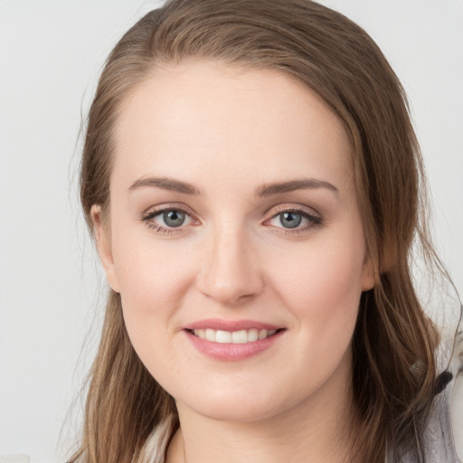 Joyful white young-adult female with long  brown hair and grey eyes