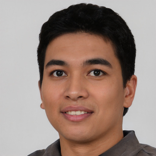 Joyful asian young-adult male with short  black hair and brown eyes