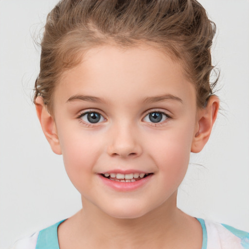 Joyful white child female with short  brown hair and brown eyes