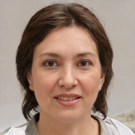 Joyful white adult female with medium  brown hair and brown eyes