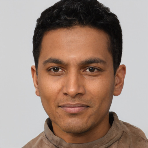Joyful latino young-adult male with short  black hair and brown eyes