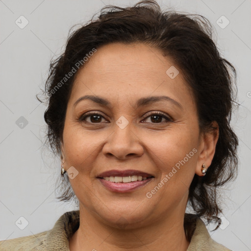 Joyful latino adult female with medium  brown hair and brown eyes