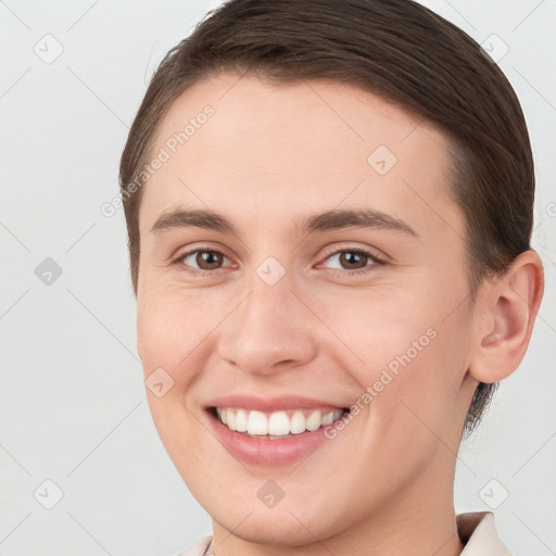 Joyful white young-adult female with short  brown hair and brown eyes