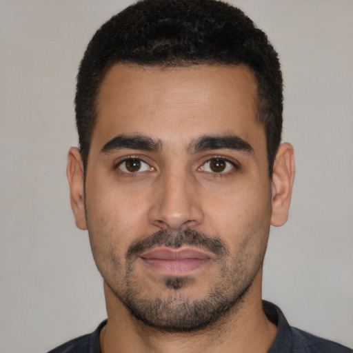 Neutral latino young-adult male with short  black hair and brown eyes