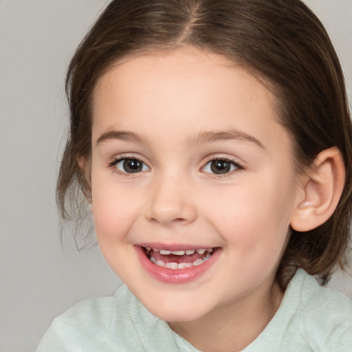 Joyful white child female with medium  brown hair and brown eyes