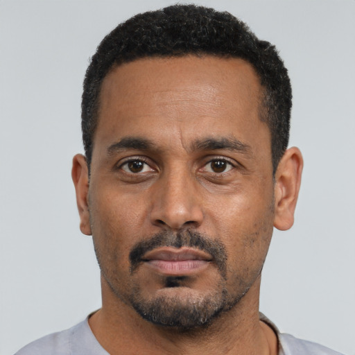 Neutral black young-adult male with short  black hair and brown eyes