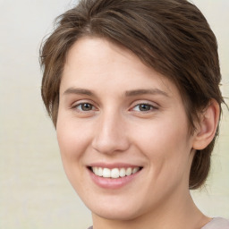 Joyful white young-adult female with medium  brown hair and green eyes