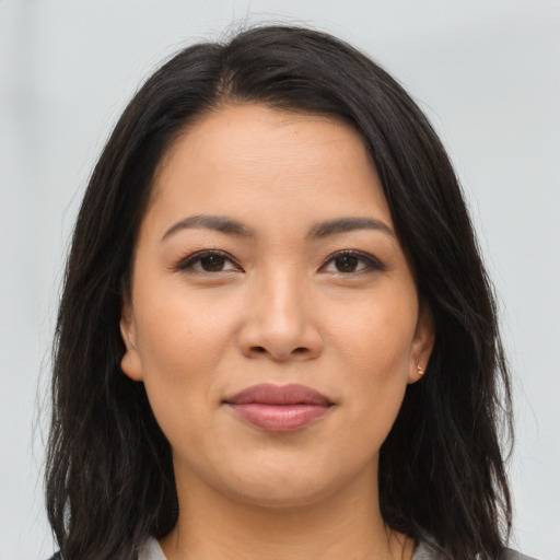 Joyful asian young-adult female with long  brown hair and brown eyes