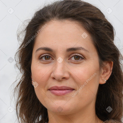 Joyful white adult female with long  brown hair and brown eyes