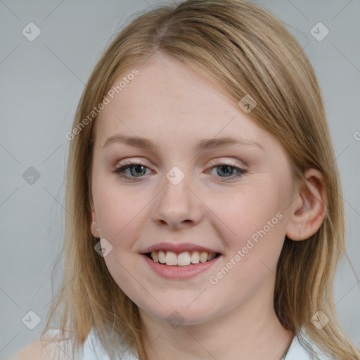 Joyful white young-adult female with medium  brown hair and blue eyes