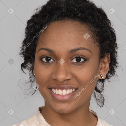 Joyful black young-adult female with long  brown hair and brown eyes