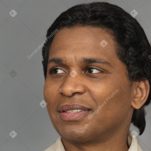 Joyful black adult male with short  black hair and brown eyes