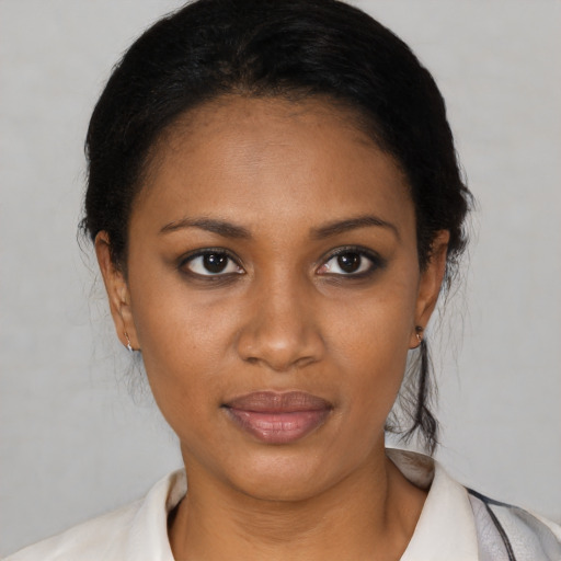 Joyful black young-adult female with short  black hair and brown eyes