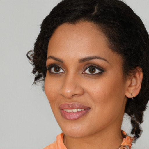 Joyful black young-adult female with medium  brown hair and brown eyes