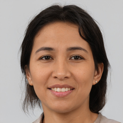 Joyful asian young-adult female with medium  brown hair and brown eyes