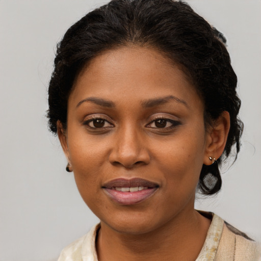 Joyful black young-adult female with medium  brown hair and brown eyes