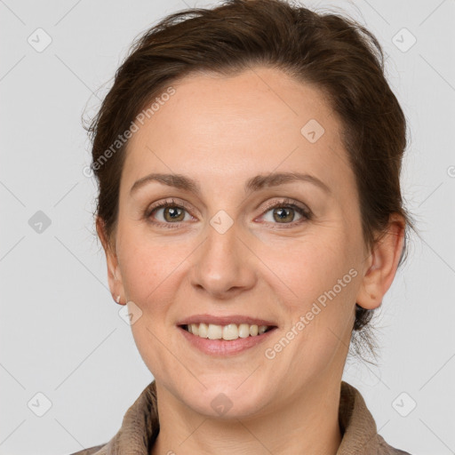 Joyful white adult female with medium  brown hair and grey eyes