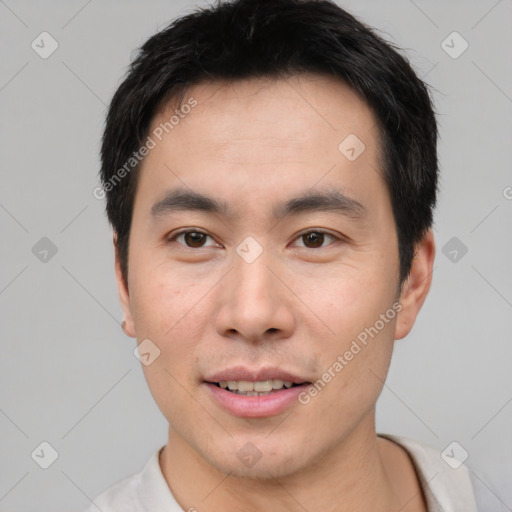 Joyful white young-adult male with short  black hair and brown eyes