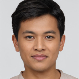 Joyful asian young-adult male with short  black hair and brown eyes