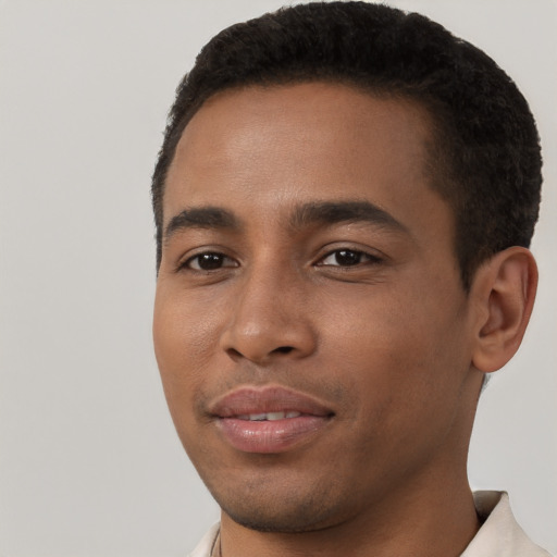 Joyful black young-adult male with short  brown hair and brown eyes