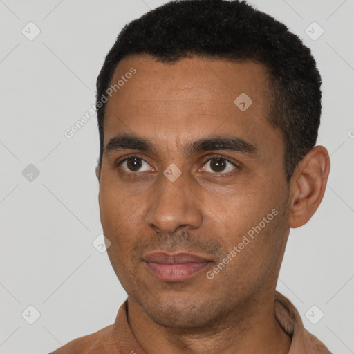 Joyful black young-adult male with short  black hair and brown eyes