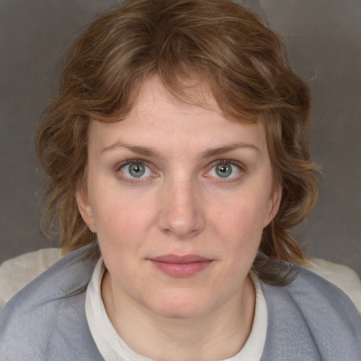 Joyful white young-adult female with medium  brown hair and blue eyes