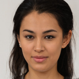 Joyful latino young-adult female with long  brown hair and brown eyes