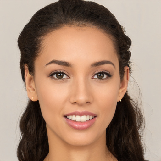 Joyful white young-adult female with long  brown hair and brown eyes