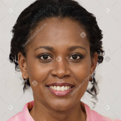 Joyful black adult female with medium  brown hair and brown eyes