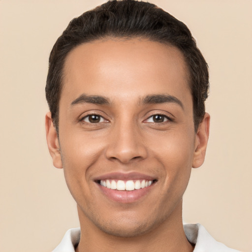 Joyful white young-adult male with short  black hair and brown eyes