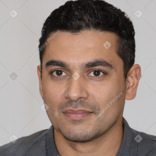 Joyful latino young-adult male with short  black hair and brown eyes