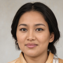 Joyful latino young-adult female with medium  brown hair and brown eyes