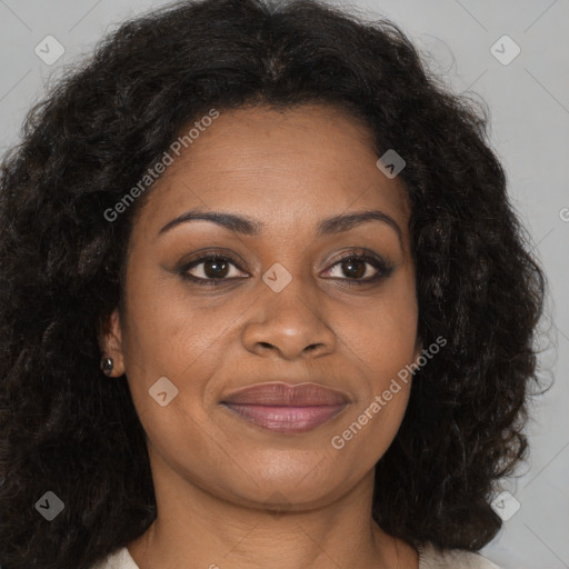 Joyful black young-adult female with long  brown hair and brown eyes