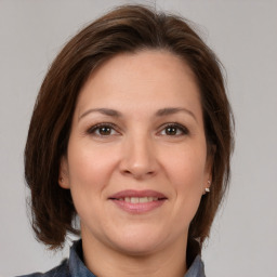 Joyful white adult female with medium  brown hair and brown eyes